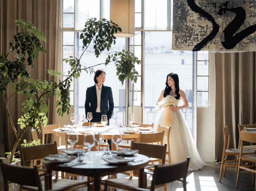 Teluk Bayu Studio Penang wedding portrait: couple gazes into each other's eyes with soft smiles with black tuxedo with subtle check pattern under studio lights and satin gown bodice with subtle sheen under soft lighting