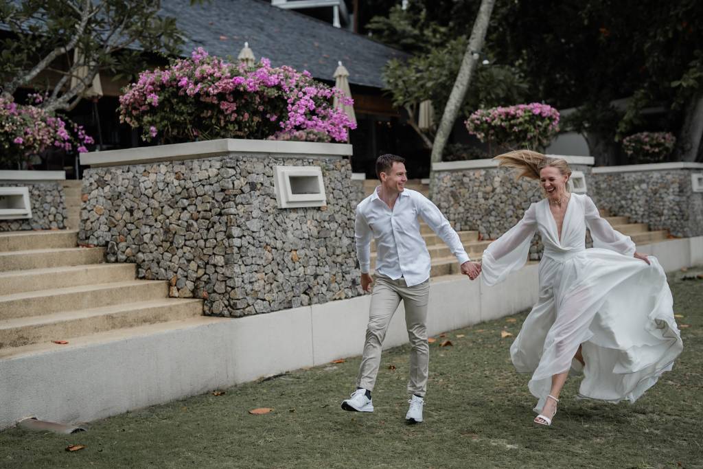 Intimate candid laughter between the couple captured at Pangkor Laut Resort, Perak — bride and groom exchange soft smiles ...