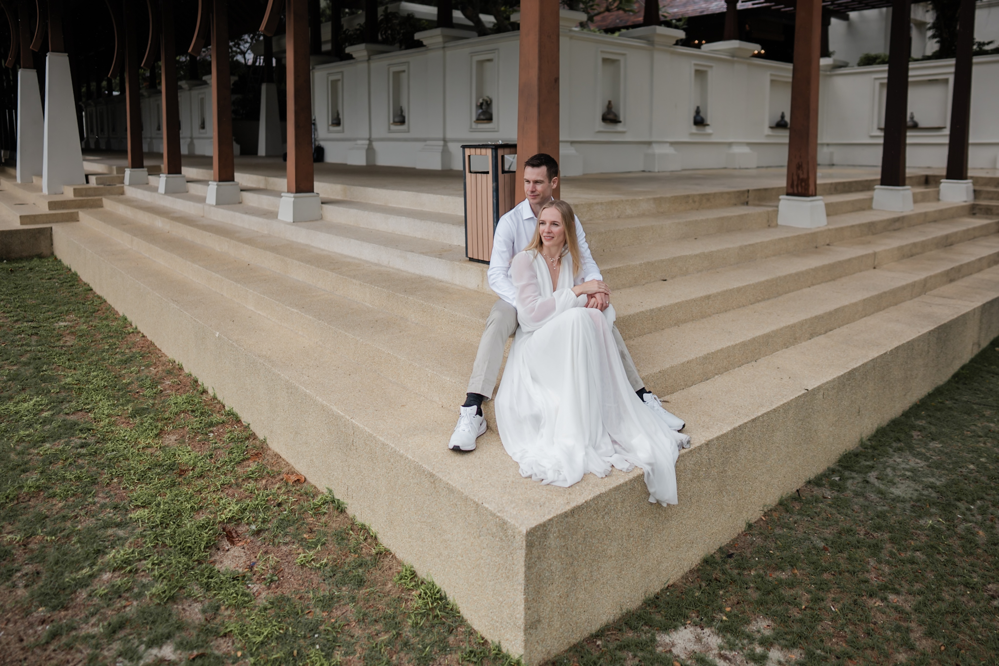Couple seated on resort steps during a quiet Pangkor Laut Resort portrait