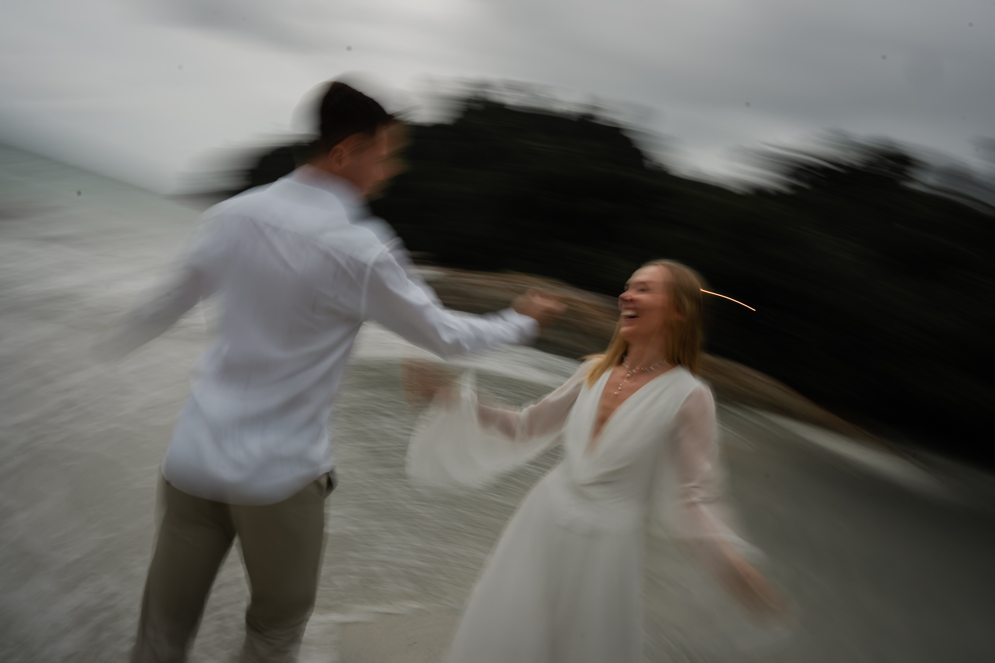 Intimate candid laughter between the couple captured at Pangkor Laut Resort, Perak &mdash; bride and groom exchange soft smiles ...